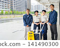 Four men and women who are staff members for building cleaning and facility maintenance. 141490300