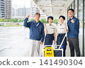Four men and women who are staff members for building cleaning and facility maintenance. 141490304