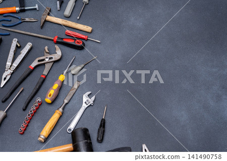 Assortment of Hand instruments Tools on Dark Background Assortment of Hand instruments Tools on Dark Background 141490758