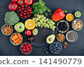 Healthy antioxidant rich foods flat lay on dark background with copy space 141490779