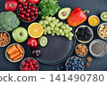 Healthy antioxidant rich foods flat lay on dark background with copy space 141490780