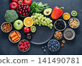 Healthy antioxidant rich foods flat lay on dark background with copy space 141490781