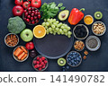 Healthy antioxidant rich foods flat lay on dark background with copy space 141490782