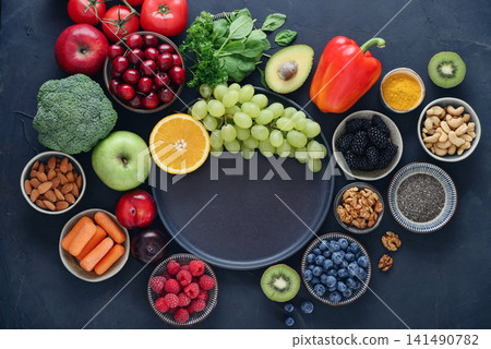 Healthy antioxidant rich foods flat lay on dark background with copy space Healthy antioxidant rich foods flat lay on dark background with copy space 141490782