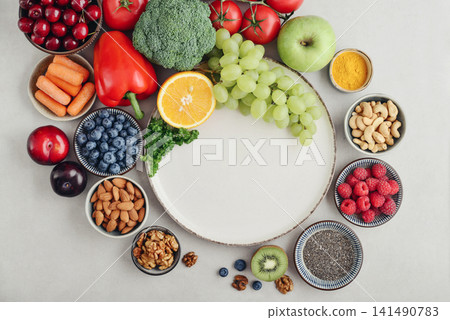 Healthy antioxidant rich foods flat lay on light background with copy space Healthy antioxidant rich foods flat lay on light background with copy space 141490783