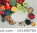 Healthy antioxidant rich foods flat lay on light background with copy space 141490784