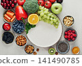 Healthy antioxidant rich foods flat lay on light background with copy space 141490785