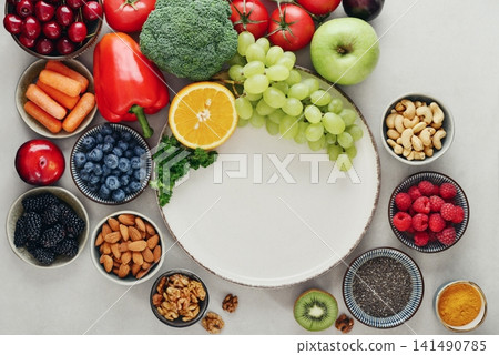 Healthy antioxidant rich foods flat lay on light background with copy space 141490785