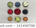 Healthy antioxidant rich fruits, berries and nuts on light background 141490786