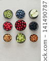 Healthy antioxidant rich fruits, berries and nuts on light background 141490787