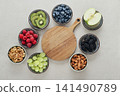 Healthy antioxidant rich fruits, berries and nuts on light background 141490789