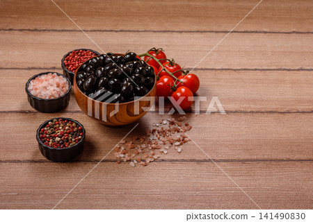 Black canned olives without pits for salads and snacks. Black olives without pits Black canned olives without pits for salads and snacks. Black olives without pits 141490830