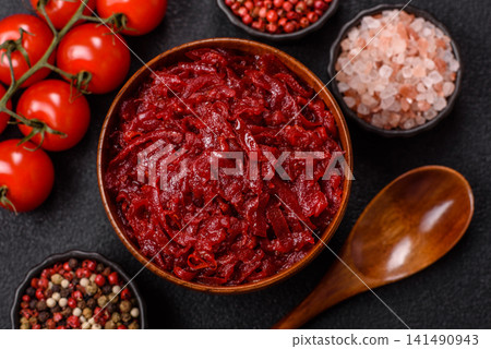 Grated beetroot with salt and spices as an ingredient for borscht or a vegan salad. Grated beetroot Grated beetroot with salt and spices as an ingredient for borscht or a vegan salad. Grated beetroot 141490943