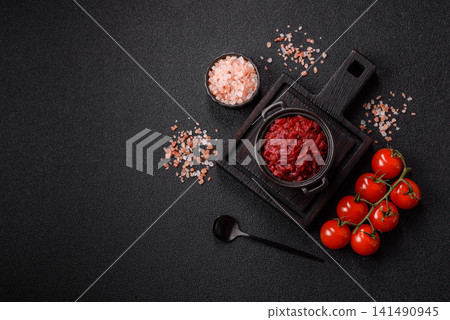 Grated beetroot with salt and spices as an ingredient for borscht or a vegan salad. Grated beetroot Grated beetroot with salt and spices as an ingredient for borscht or a vegan salad. Grated beetroot 141490945