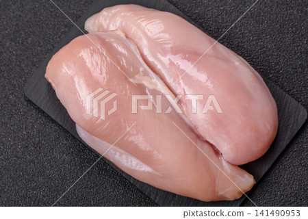 Fresh raw chicken fillet with salt and spices for home cooking. Raw chicken fillet Fresh raw chicken fillet with salt and spices for home cooking. Raw chicken fillet 141490953