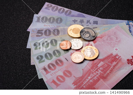 Taiwan, Taiwanese paper banknotes and coins, dollars of various denominations. Taiwanese dollars Taiwan, Taiwanese paper banknotes and coins, dollars of various denominations. Taiwanese dollars 141490966