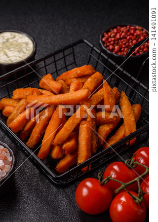 Seasoned sweet potato fries with sauce, fast food. Sweet potato fries Seasoned sweet potato fries with sauce, fast food. Sweet potato fries 141491091