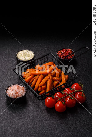 Seasoned sweet potato fries with sauce, fast food. Sweet potato fries Seasoned sweet potato fries with sauce, fast food. Sweet potato fries 141491093