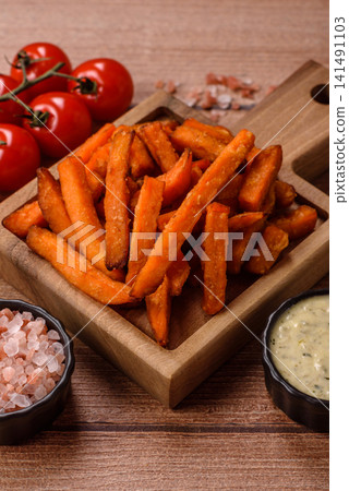 Seasoned sweet potato fries with sauce, fast food. Sweet potato fries Seasoned sweet potato fries with sauce, fast food. Sweet potato fries 141491103