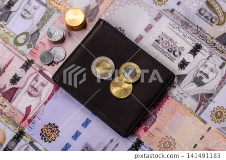 Saudi Arabia paper money, riyal banknotes and coins as currency for exchange. Saudi Arabia money Saudi Arabia paper money, riyal banknotes and coins as currency for exchange. Saudi Arabia money 141491183