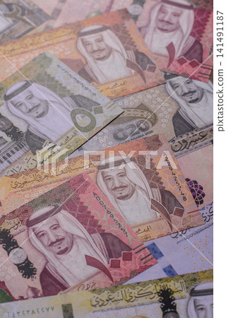 Saudi Arabia paper money, riyal banknotes and coins as currency for exchange. Saudi Arabia money Saudi Arabia paper money, riyal banknotes and coins as currency for exchange. Saudi Arabia money 141491187