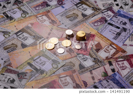 Saudi Arabia paper money, riyal banknotes and coins as currency for exchange. Saudi Arabia money Saudi Arabia paper money, riyal banknotes and coins as currency for exchange. Saudi Arabia money 141491190