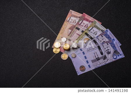 Saudi Arabia paper money, riyal banknotes and coins as currency for exchange. Saudi Arabia money Saudi Arabia paper money, riyal banknotes and coins as currency for exchange. Saudi Arabia money 141491198