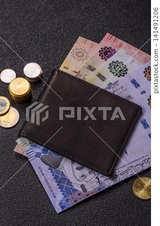 Saudi Arabia paper money, riyal banknotes and coins as currency for exchange. Saudi Arabia money Saudi Arabia paper money, riyal banknotes and coins as currency for exchange. Saudi Arabia money 141491206
