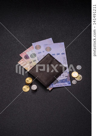 Saudi Arabia paper money, riyal banknotes and coins as currency for exchange. Saudi Arabia money Saudi Arabia paper money, riyal banknotes and coins as currency for exchange. Saudi Arabia money 141491211