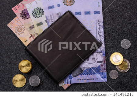 Saudi Arabia paper money, riyal banknotes and coins as currency for exchange. Saudi Arabia money Saudi Arabia paper money, riyal banknotes and coins as currency for exchange. Saudi Arabia money 141491213