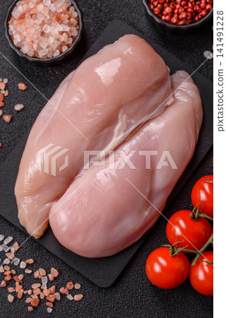 Fresh raw chicken fillet with salt and spices for home cooking. Raw chicken fillet Fresh raw chicken fillet with salt and spices for home cooking. Raw chicken fillet 141491228