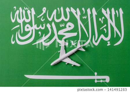 An airplane on the on the flag of Saudi Arabia as a conceptual backdrop An airplane on the on the flag of Saudi Arabia as a conceptual backdrop 141491283