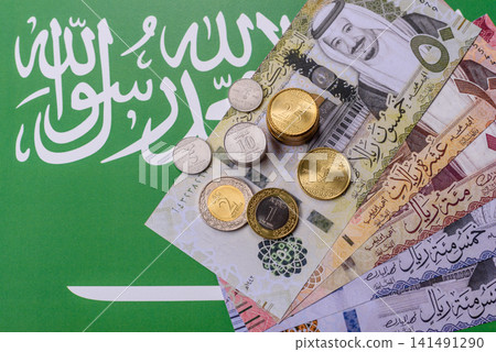Saudi Arabia paper money, riyal banknotes and coins as currency for exchange. Saudi Arabia money Saudi Arabia paper money, riyal banknotes and coins as currency for exchange. Saudi Arabia money 141491290