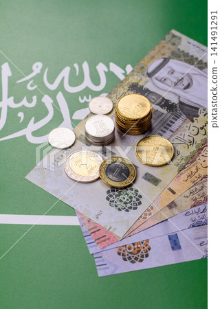 Saudi Arabia paper money, riyal banknotes and coins as currency for exchange. Saudi Arabia money Saudi Arabia paper money, riyal banknotes and coins as currency for exchange. Saudi Arabia money 141491291