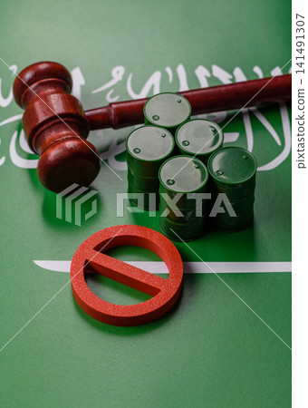 Metal barrels of oil, gas, or chemicals bearing on the flag of Saudi Arabia and a ban sign, embargo 141491307