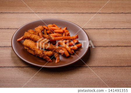 Seasoned sweet potato fries with sauce, fast food. Sweet potato fries Seasoned sweet potato fries with sauce, fast food. Sweet potato fries 141491355