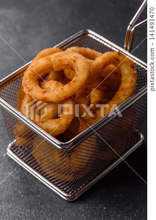 Deep fried breaded onion or squid rings, crispy fast food snacks. Fried onion or squid rings Deep fried breaded onion or squid rings, crispy fast food snacks. Fried onion or squid rings 141491470
