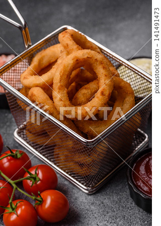 Deep fried breaded onion or squid rings, crispy fast food snacks. Fried onion or squid rings Deep fried breaded onion or squid rings, crispy fast food snacks. Fried onion or squid rings 141491473