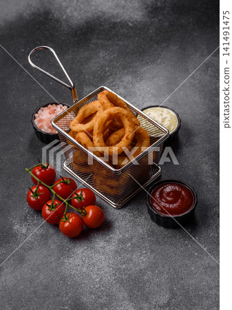 Deep fried breaded onion or squid rings, crispy fast food snacks. Fried onion or squid rings Deep fried breaded onion or squid rings, crispy fast food snacks. Fried onion or squid rings 141491475