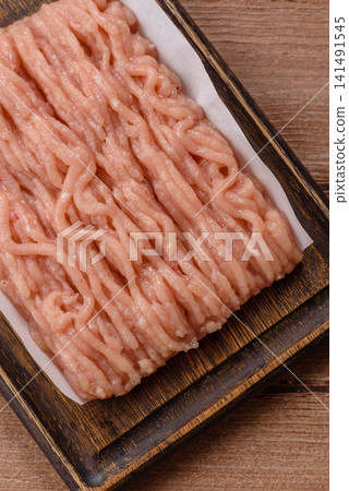 Fresh raw ground chicken, poultry meat for home cooking. Ground chicken Fresh raw ground chicken, poultry meat for home cooking. Ground chicken 141491545