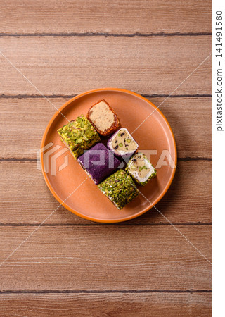 Turkish delight or lokum is a traditional Eastern sweet made with nuts. Turkish delight, lokum Turkish delight or lokum is a traditional Eastern sweet made with nuts. Turkish delight, lokum 141491580