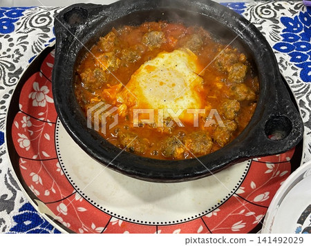 Traditional Moroccan Kefta Meatball Tajine with Egg in Black Clay Pot Traditional Moroccan Kefta Meatball Tajine with Egg in Black Clay Pot 141492029