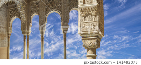 Arches in Islamic (Moorish) style (against the background of a beautiful sky with clouds) in Alhambra, Granada, Spain Arches in Islamic (Moorish) style (against the background of a beautiful sky with clouds) in Alhambra, Granada, Spain 141492073