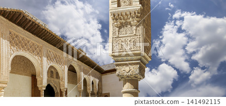 Arches in Islamic (Moorish) style (against the background of a beautiful sky with clouds) in Alhambra, Granada, Spain Arches in Islamic (Moorish) style (against the background of a beautiful sky with clouds) in Alhambra, Granada, Spain 141492115
