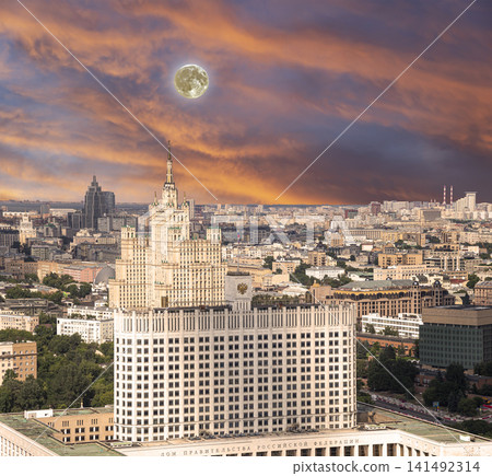 Aerial view of Moscow against the romantic evening sky with clouds and rays of the sun with the super moon. Government House of the Russian Federation (White House)-written in Russian, Russia Aerial view of Moscow against the romantic evening sky with clouds and rays of the sun with the super moon. Government House of the Russian Federation (White House)-written in Russian, Russia 141492314