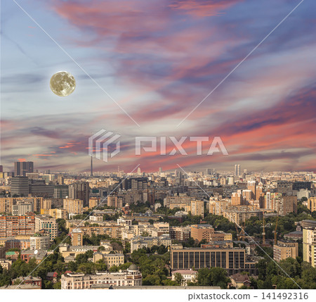 Aerial view of center of Moscow (City) against the background of a romantic evening sky with clouds and rays of the sun with the super moon, Russia Aerial view of center of Moscow (City) against the background of a romantic evening sky with clouds and rays of the sun with the super moon, Russia 141492316