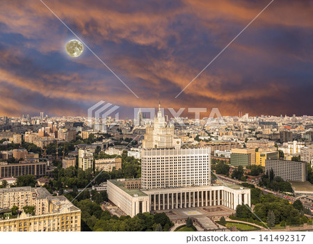 Aerial view of Moscow against the romantic evening sky with clouds and rays of the sun with the super moon. Government House of the Russian Federation (White House)-written in Russian, Russia Aerial view of Moscow against the romantic evening sky with clouds and rays of the sun with the super moon. Government House of the Russian Federation (White House)-written in Russian, Russia 141492317