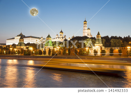 Night view of the Moskva River and Kremlin, Russia, Moscow (most popular view). Against the background of a beautiful sky with clouds, with the moon Night view of the Moskva River and Kremlin, Russia, Moscow (most popular view). Against the background of a beautiful sky with clouds, with the moon 141492333
