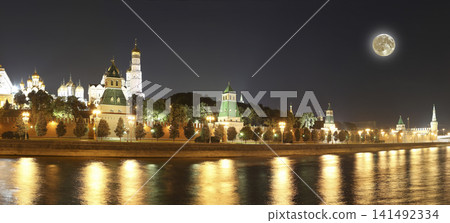 Night view of the Moskva River and Kremlin, Russia, Moscow (most popular view). Against the background of a beautiful sky with clouds, with the moon Night view of the Moskva River and Kremlin, Russia, Moscow (most popular view). Against the background of a beautiful sky with clouds, with the moon 141492334