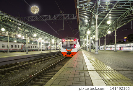 Train on Moscow passenger platform at night (Belorussky railway station) night, with the super moon -- is one of the nine main railway stations in Moscow, Russia. 141492365